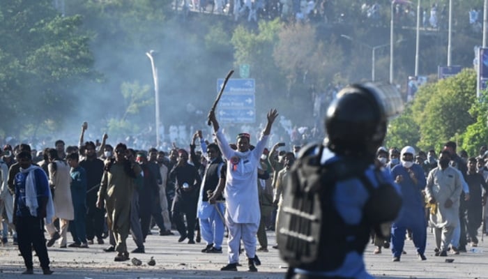 PTI members and supporters clash with police in Islamabad on May 10, 2023. —AFP