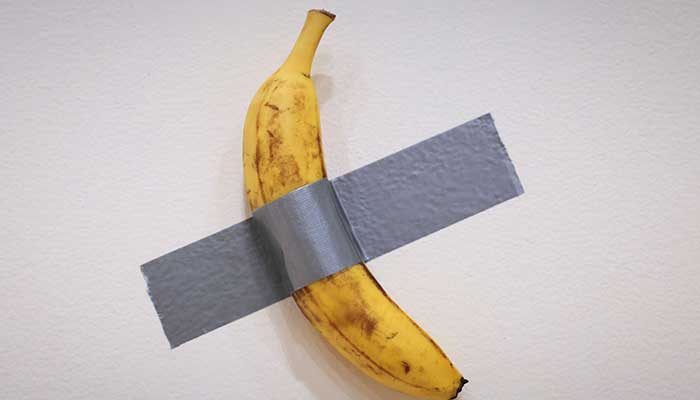 Italian visual artist Maurizio Cattelans duct-taped Banana entitled Comedian, is on display during a media preview at Sothebys in New York, on November 8, 2024. — AFP