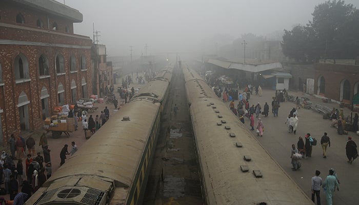 People walk to board trains amid smog and air pollution at a railway station in Lahore, Pakistan November 14, 2024. — Reuters