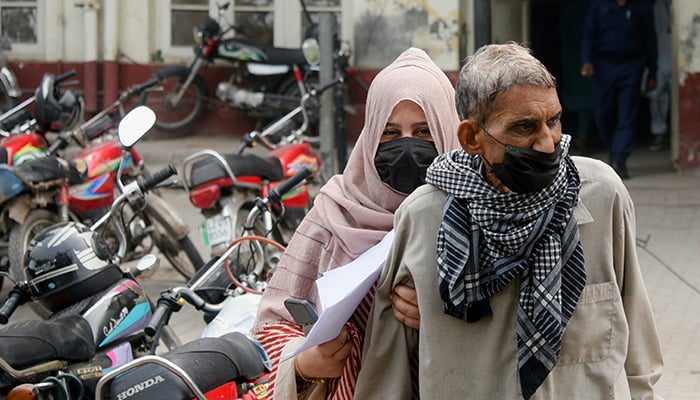 People wear masks to protect themselves against smog and air pollution while leaving a hospital in Lahore, Pakistan November 13, 2024. — Reuters