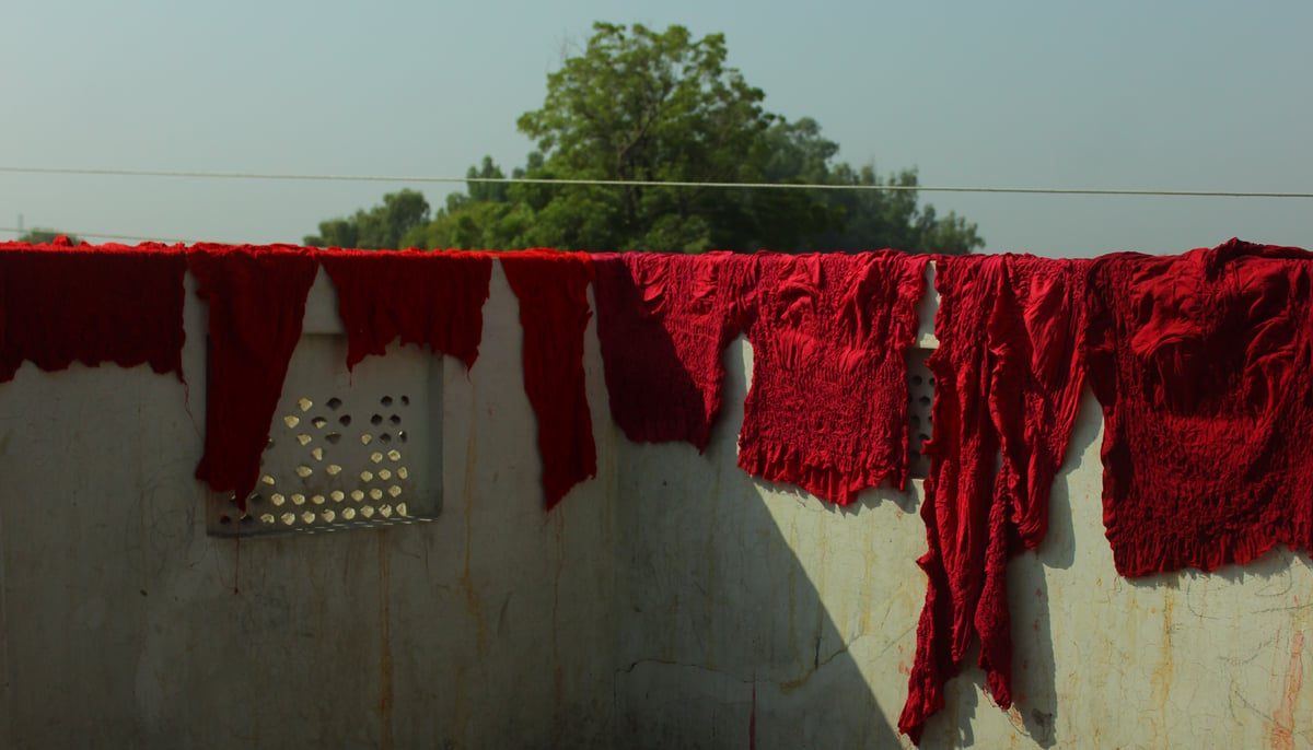 Chunari fabric is hanged on a wall at a home in Abbas Nagar in Bahawalpur. — Photo by author