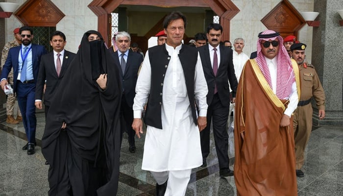 In this May 2019 photo, former prime minister Imran Khan and his wife visiting the Prophet Mosque (PBUH) in Madina. — Saudi Press Agency/File