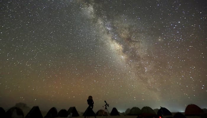 The Milky Way is seen in the night sky around telescopes and camps of people over rocks in the White Desert north of the Farafra Oasis southwest of Cairo May 16, 2015. — Reuters