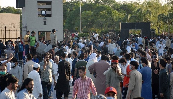 Charged mobs gather in front of the main entrance of General Headquarters during a protest against the arrest of their leader, in Rawalpindi on May 9, 2023. — AFP