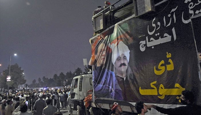 PTI activists walk along the central stage on truck during a protest in Islamabad. — Online/File