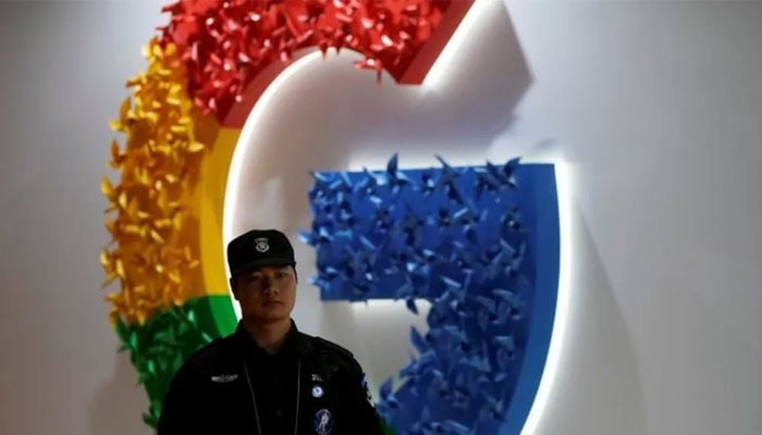 A representational image of a security guard standing in front of a Google logo installed on a wall. — Reuters