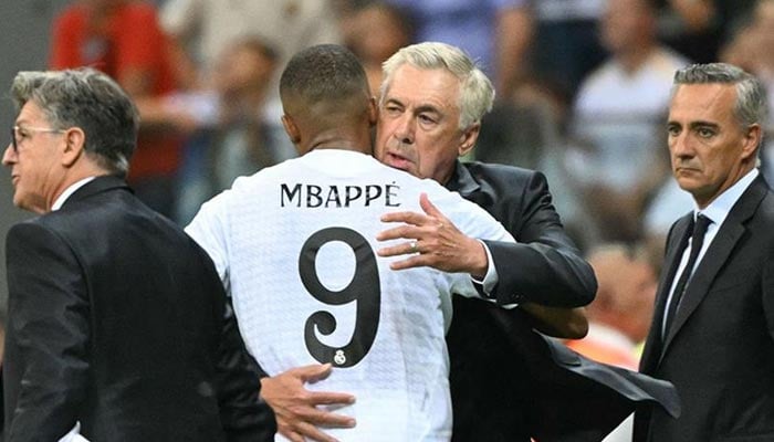 Real Madrid forward Kylian Mbappe hugs manager Carlo Ancelotti during UEFA Super Cup football match between Real Madrid and Atalanta BC in Warsaw, on August 14, 2024. — AFP