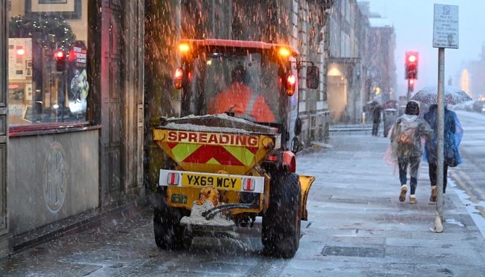 A snow plough clears the snow during Storm Bert, along George Street in Edinburgh, Scotland, Britain, November 23, 2024. — Reuters