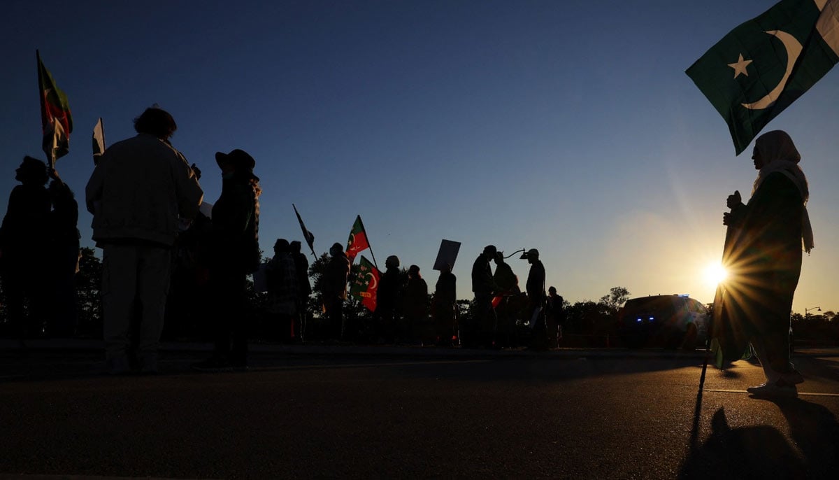 PTI supporters silhouetted against the sun in Palm Beach, Florida, November 23, 2024. — Reuters