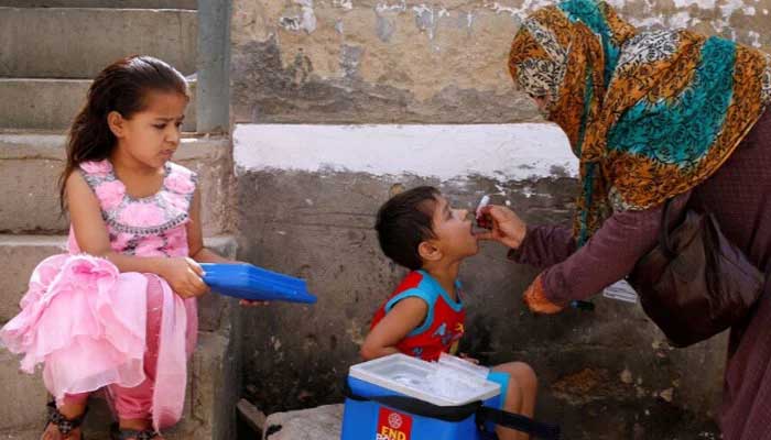 A boy receives polio vaccine drops, during an inoculation campaign, in a low-income neighbourhood in Karachi. — Reuters/File