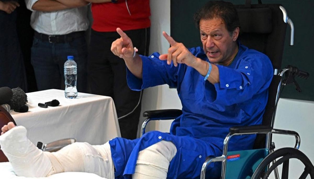 In this picture taken on on November 4, 2022, former prime minister Imran Khan addresses the media representatives at a hospital in Lahore, a day after an assassination attempt on him. — AFP