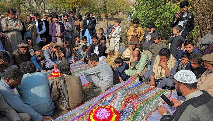 People mourn over the graves of relatives who were killed after gunmen opened fire on passenger vehicles in District Kurram of Khyber Pakhtunkhwa on November 22, 2024. — Reuters