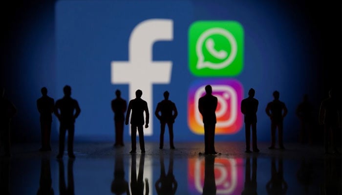 Small toy figures are seen in front of displayed Facebook, Whatsapp and Instagram logos in this illustration taken October 4, 2021.