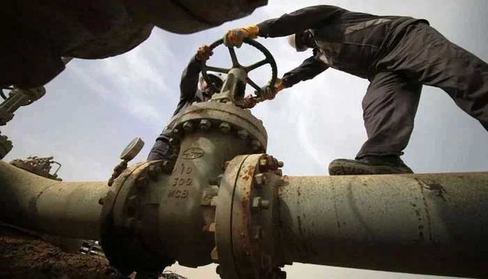 A representational image showing two employees work on a gas pipeline. — AFP/File