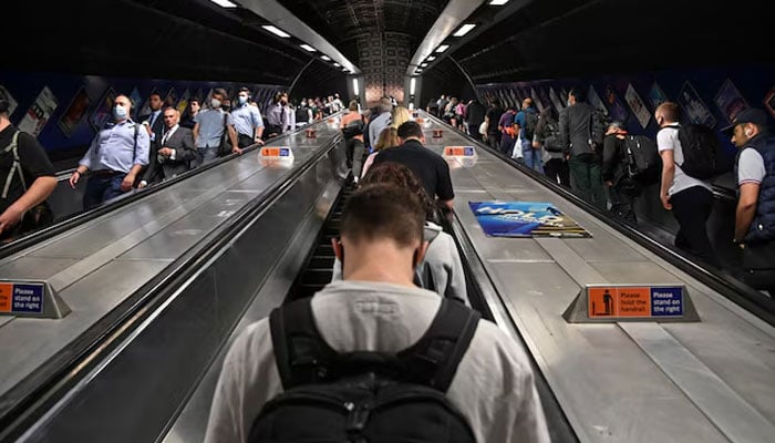 Workers travel through London Bridge rail and underground station during the morning rush hour in London, Britain, September 8, 2021. — Reuters