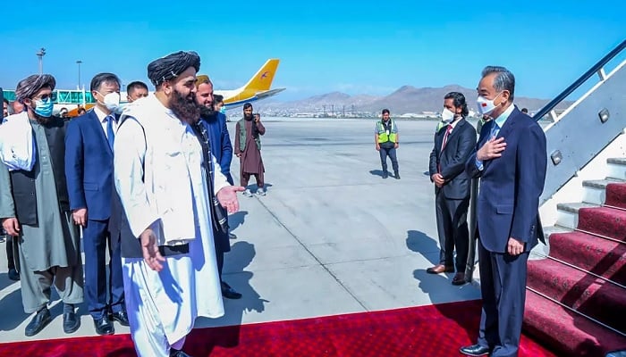 Taliban Foreign Minister Mawlawi Amir Khan Muttaqi greets Chinese Foreign Minister Wang Yi at the airport. — AFP/File