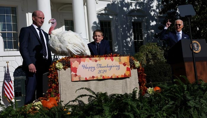 US President Joe Biden pardons the National Thanksgiving Turkey as John Zimmerman, chair of the National Turkey Federation, and his son Grant look on during the annual ceremony on the South Lawn at the White House in Washington, U.S., November 25, 2024. — Reuters