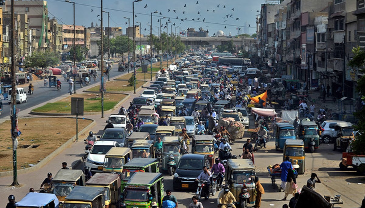 Commuters make their way along a busy road in Karachi, Pakistan, on May 11, 2020. — AFP