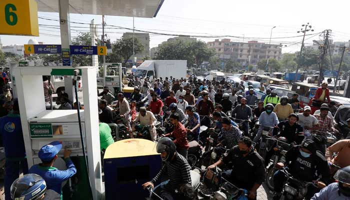 Motorcyclists wait for their turn to get petrol at a petrol station. — Reuters/File