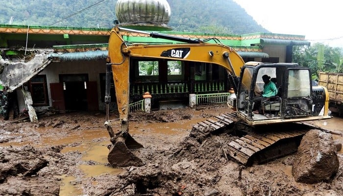 An excavator moves soil during the search and rescue of victims on the site of a landslide at Semangat Gunung Village in Karo, Indonesia, November 25, 2024. — Reuters