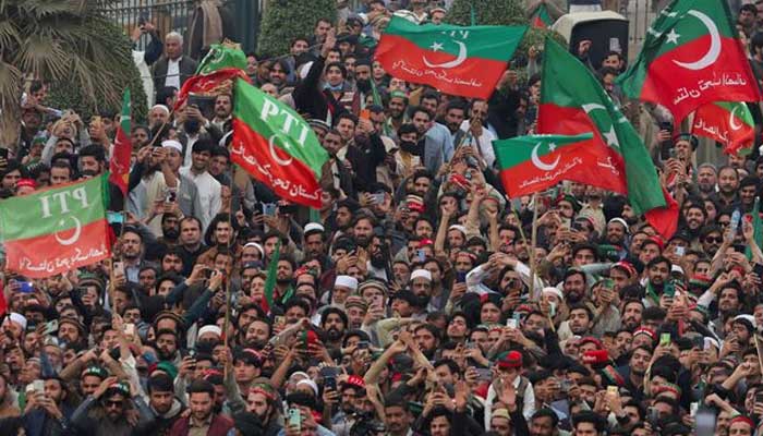 Supporters of former prime minister Imran Khans party, the Pakistan Tehreek-e-Insaf (PTI), wave flags as they protest demanding free and fair results of the elections, in Peshawar, February 17, 2024. — Reuters