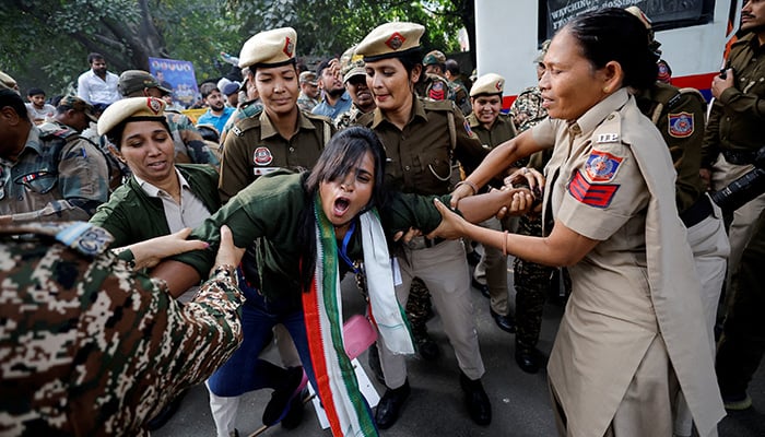 Police detain a supporter of Indias main opposition Congress party during a protest against Indian billionaire Gautam Adani in New Delhi, India. — Reuters