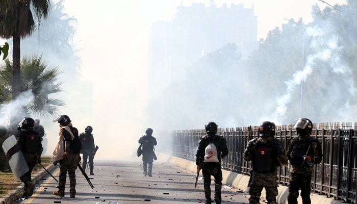 A view of the security personnel firing tear gas shell amidst clash with PTI protesters in Islamabad on November 26, 2024. — INP