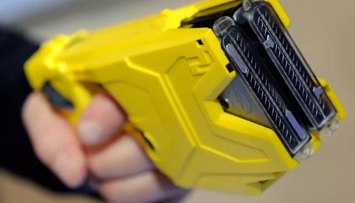 A representational image shows a person hoilding a Taser gun. — AFP/File