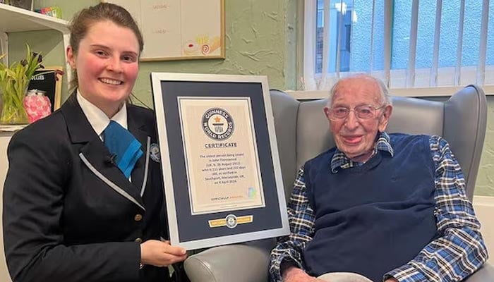 John Tinniswood, 111, poses with his certificate from the Guinness World Records, who announced that he is the worlds oldest living man, in Southport, Britain on April 4, 2024. — Reuters