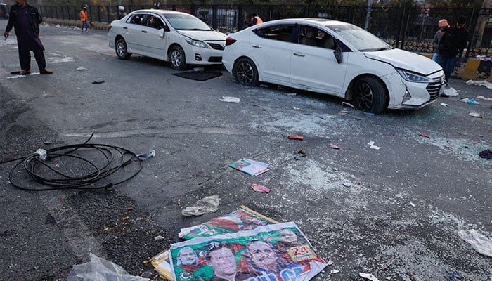 A view of campaign posters and damaged vehicles, after security forces launched a raid on supporters of former prime minister Imran Khans party PTI who had stormed the capital demanding his release on Tuesday, in Islamabad, November 27, 2024. — Reuters