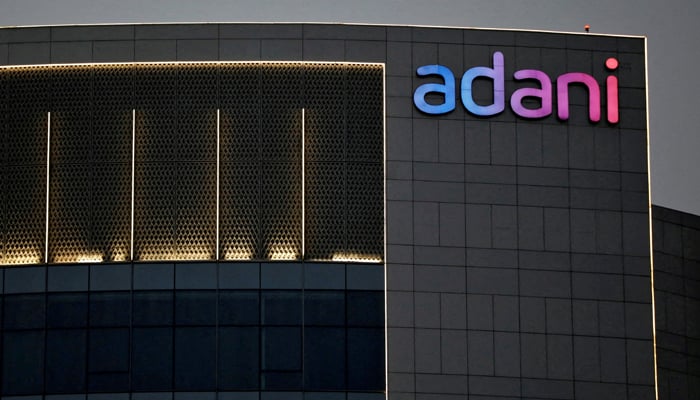 The logo of the Adani group is seen on the facade of one of its buildings on the outskirts of Ahmedabad, India, April 13, 2021. — Reuters