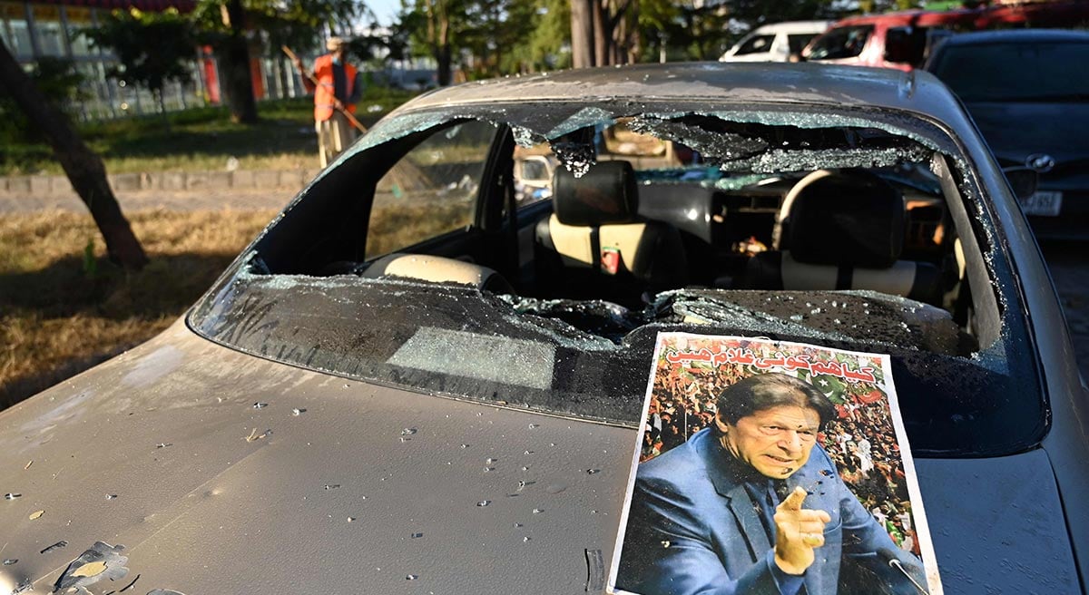 A poster of jailed former Pakistan´s prime minister Imran Khan is pictured on a vehicle that was damaged by his supporters near the red zone area in Islamabad on November 27, 2024. — AFP