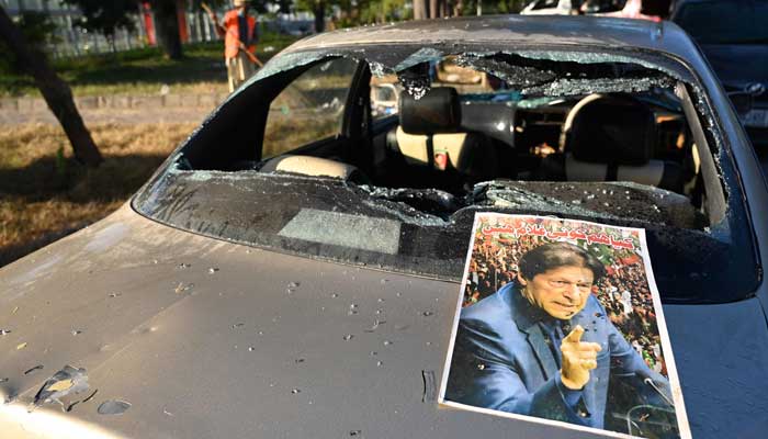 A poster of jailed PTI founder Imran Khan is pictured on a vehicle that was damaged by his supporters near the Red Zone area in Islamabad on November 27, 2024. — AFP