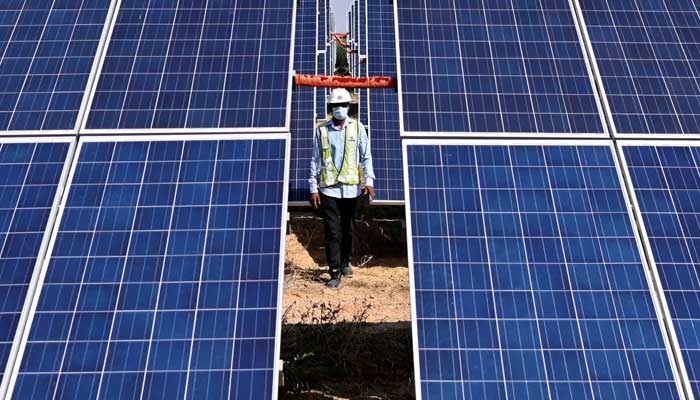 An engineer walks next to solar panels at the National Thermal Power Corporation (NTPC) site at Bhadla Solar Park in Bhadla, in the northwestern Indian state of Rajasthan. — AFP/File