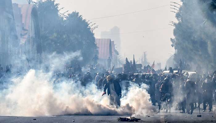 Policemen fire tear gas shells to disperse PTI supporters during a protest at the Red Zone area in Islamabad on November 26, 2024. — AFP