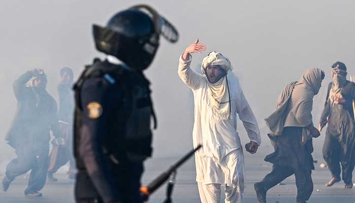 A PTI supporter gestures after tear gas was fired by the police to disperse the crowd during a protest to in Islamabad on November 26, 2024. — AFP