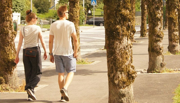 A representational image shows two people taking a stroll. — Unsplash