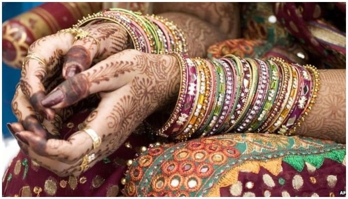 Representational image of a woman wearing bangles and henna — AFP/File