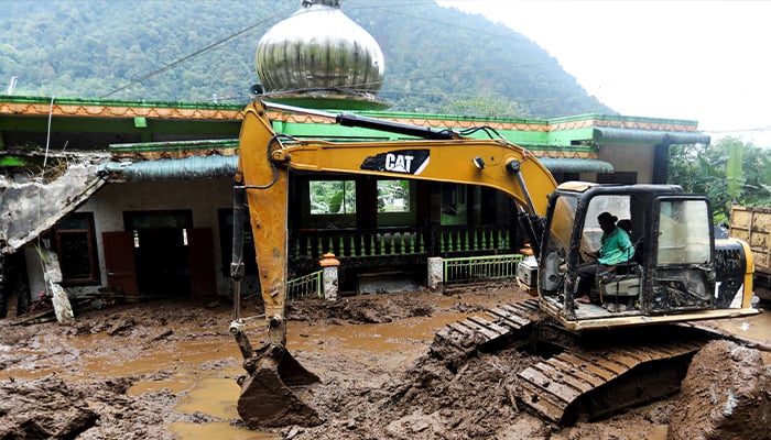 An excavator moves soil during the search and rescue of victims on the site of a landslide caused by heavy rain at Semangat Gunung Village in Karo, North Sumatra province, Indonesia, November 25, 2024. — Reuters