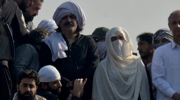 PTI founder Imran Khans wife Bushra Bibi (centre) pictured along KP CM Ali Amin Gandapur (left) during the partys protest in Islamabad on November 26, 2024. — Reuters