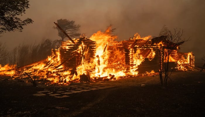 A house burns during a wildfire in Varnavas, north of Athens. — AFP/file