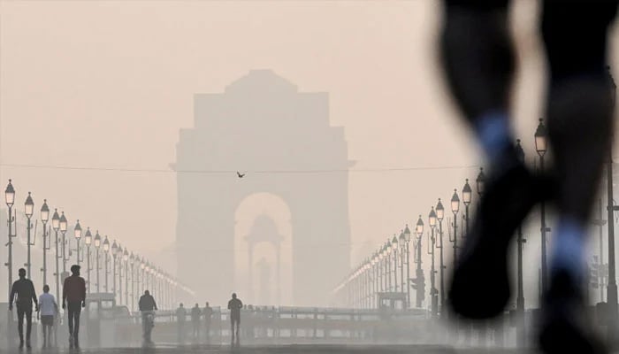 The Indian gate slightly visible due to smog swarming it because of intense air pollution in the country. — AFP/file