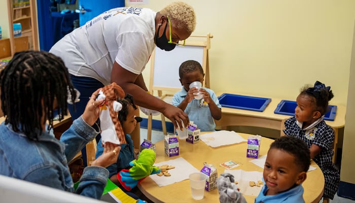 A representational image of a childcare worker dealing with children as another sits at left, with students at Wilcoxs Academy of Early Learning in New Orleans, Louisiana, US on August 24, 2021. — Reuters