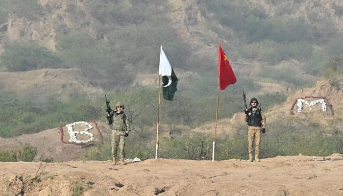 A Pakistani army soldier and a Chinese soldier pictured with the flags of the two countries at the NCTC, Pabba on November 29, 2024. — ISPR