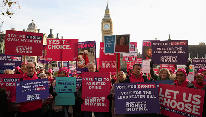 People in support of assisted dying hold placards as they gather outside the Parliament as British lawmakers debate the assisted dying law, in London, Britain, November 29, 2024. — Reuters