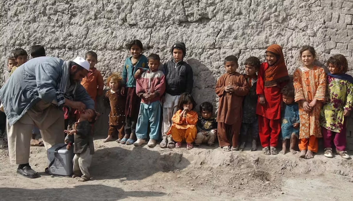 A polio worker administers anti-poliovirus vaccination on children. — Reuters/File