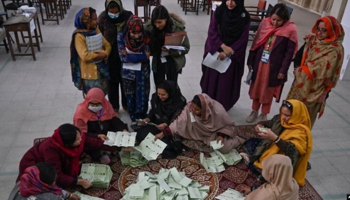 Election officials count votes after polls end in Islamabad on February 8, 2024. —AFP