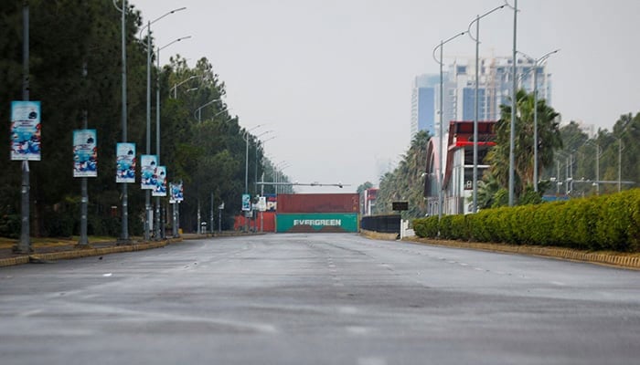 Shipping containers are kept on the main highway to prevent an anti-government rally by supporters of PTI founder Imran Khan in Islamabad on November 24, 2024. — Reuters