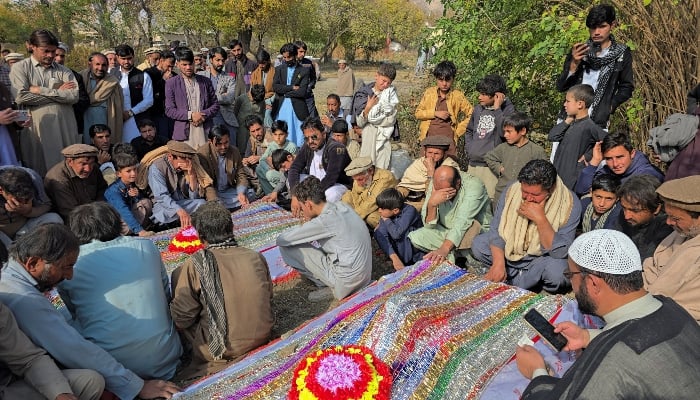 People mourn over graves of relatives who were killed after gunmen opened fire on passenger vehicles in the Kurram tribal district of Khyber Pakhtunkhwa on November 22, 2024. —Reuters