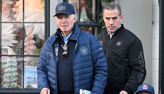 US President Joe Biden (left), accompanied by Hunter Biden, walks out of a bookstore in downtown Nantucket, Massachusetts, US, on November 29, 2024. — Reuters